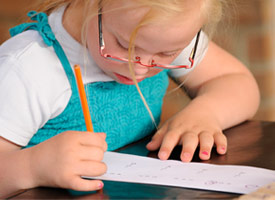 girl with down syndrom writing