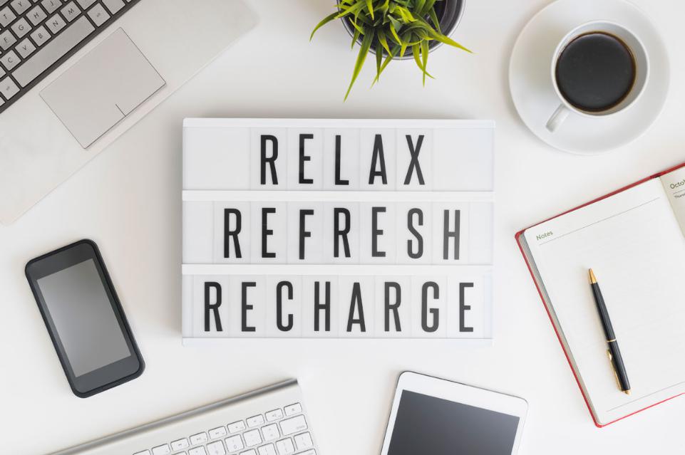 Words on a desk saying Relax, Refresh, Recharge