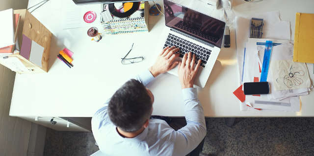 Overhead shot of man working at his desk