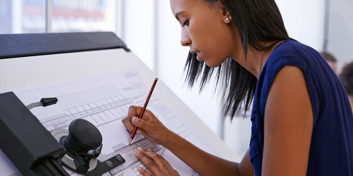 Professional woman using drafting table.