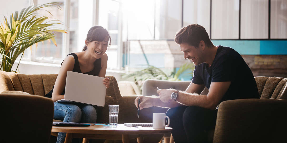 Two businesspeople having a meeting on relaxed seating.