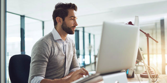 Man working at his office computer.