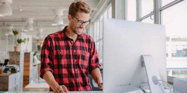 Man working at a standing desk