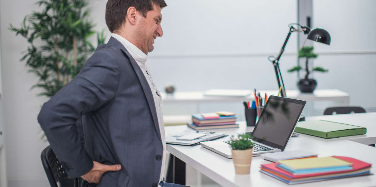 Businessman experiencing back pain.