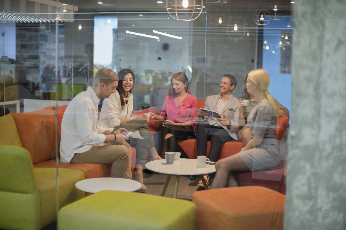 Coworkers enjoying break in a colorful leisure space