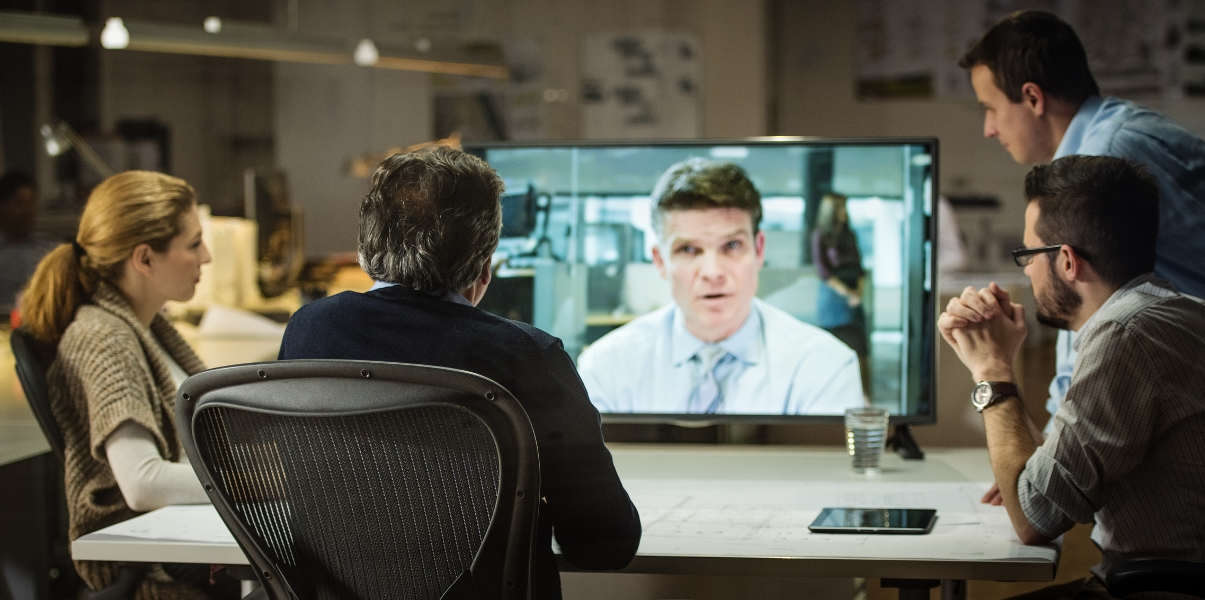Coworkers in discussion during a video meeting