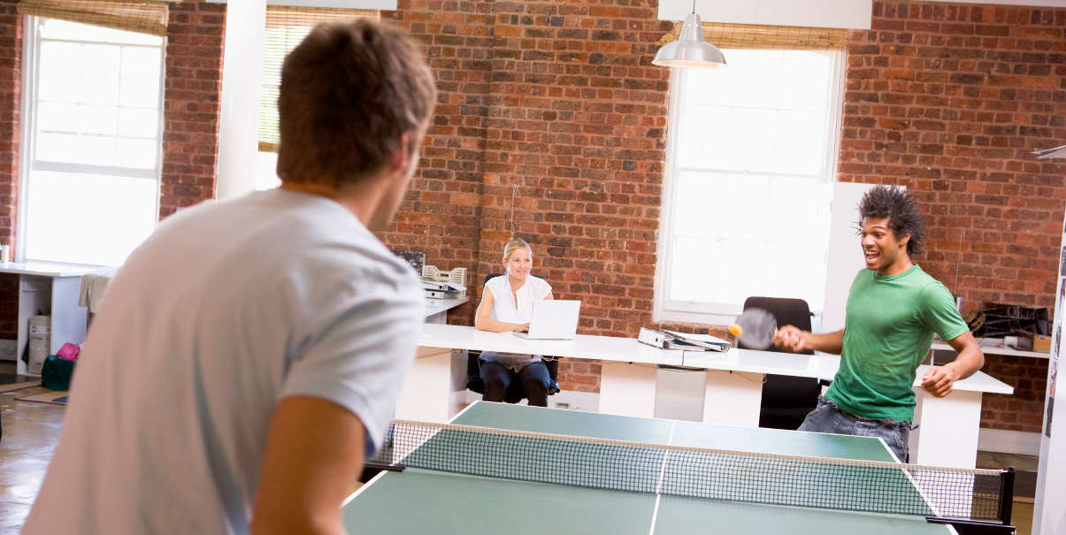 Coworkers playing table tennis