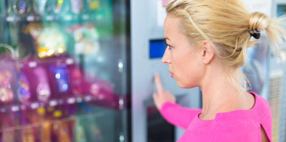 Lady using a modern vending machine.